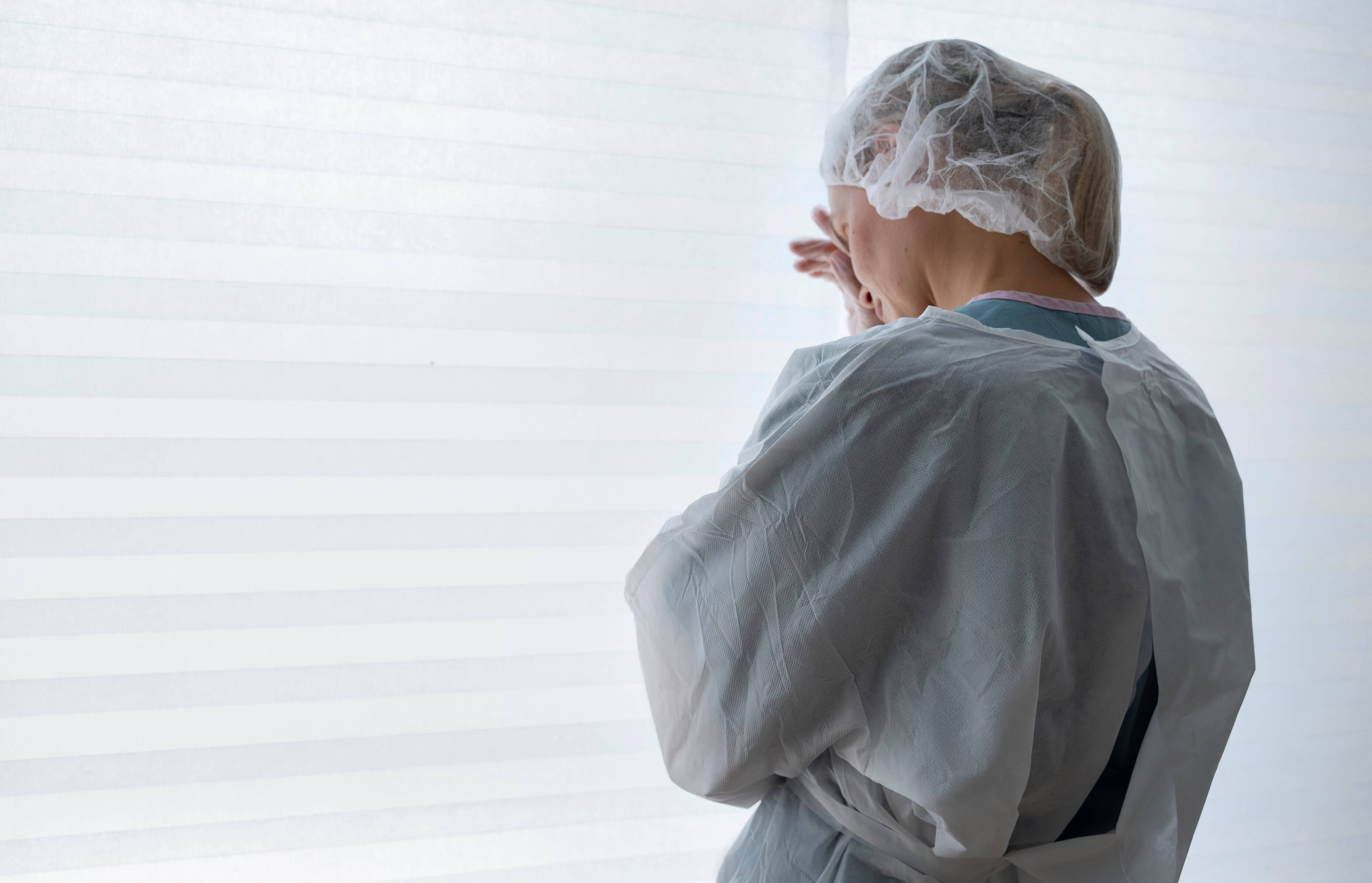 Side view of nurse wearing medical gown