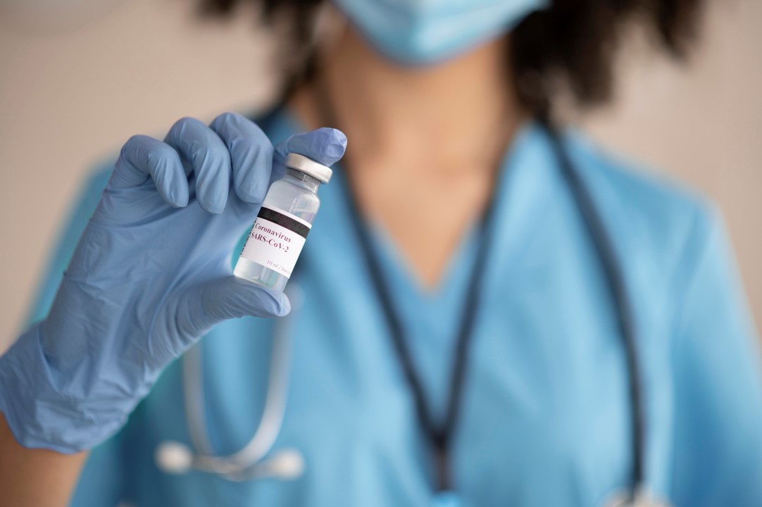 Nurse preparing vaccine for patient