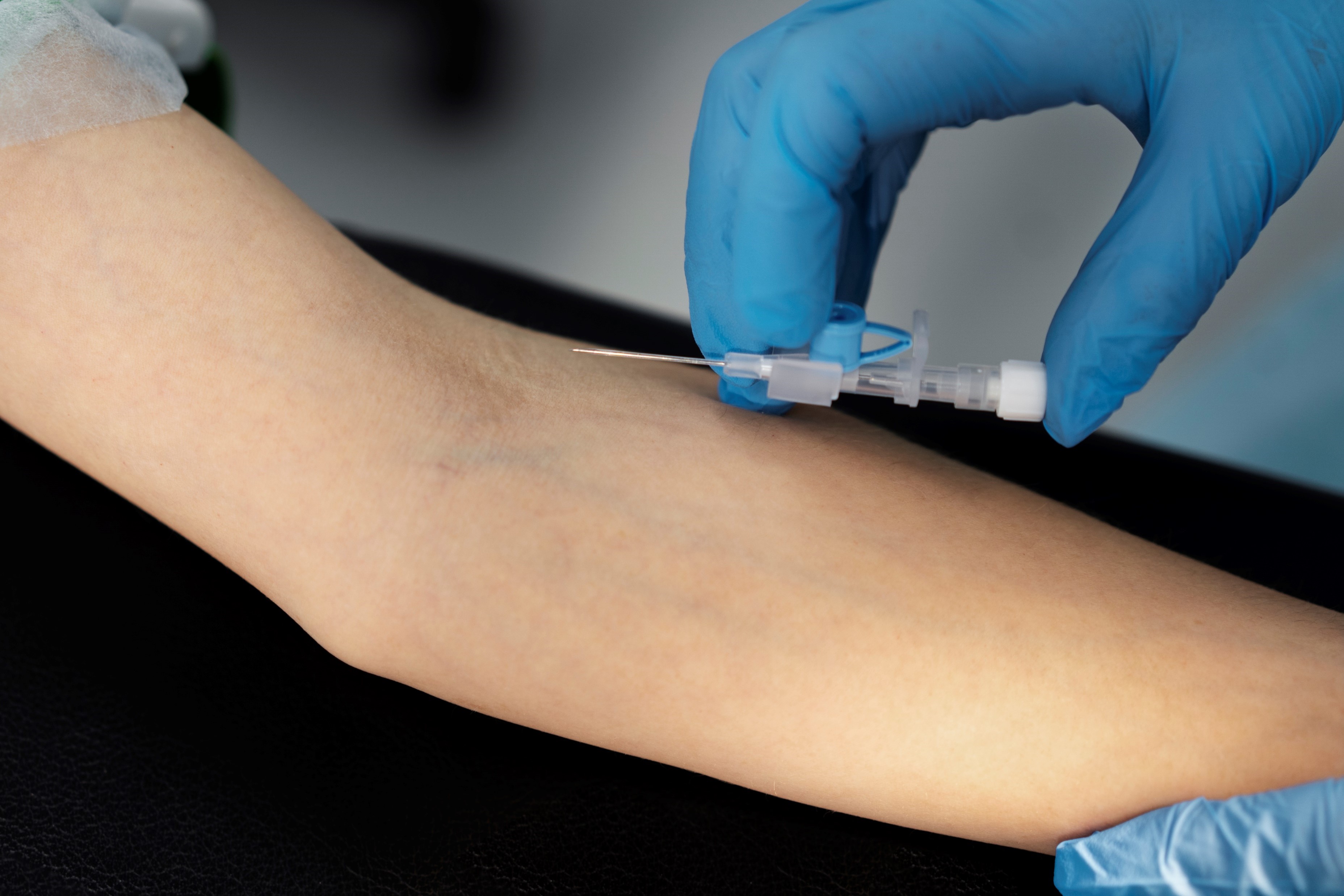 Nurse putting IV on patient's arm